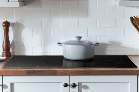 The Frigidaire FFIC3626TB induction cooktop featured with a pot 