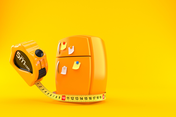 illustration of yellow refrigerator measured by a large tape measurer 