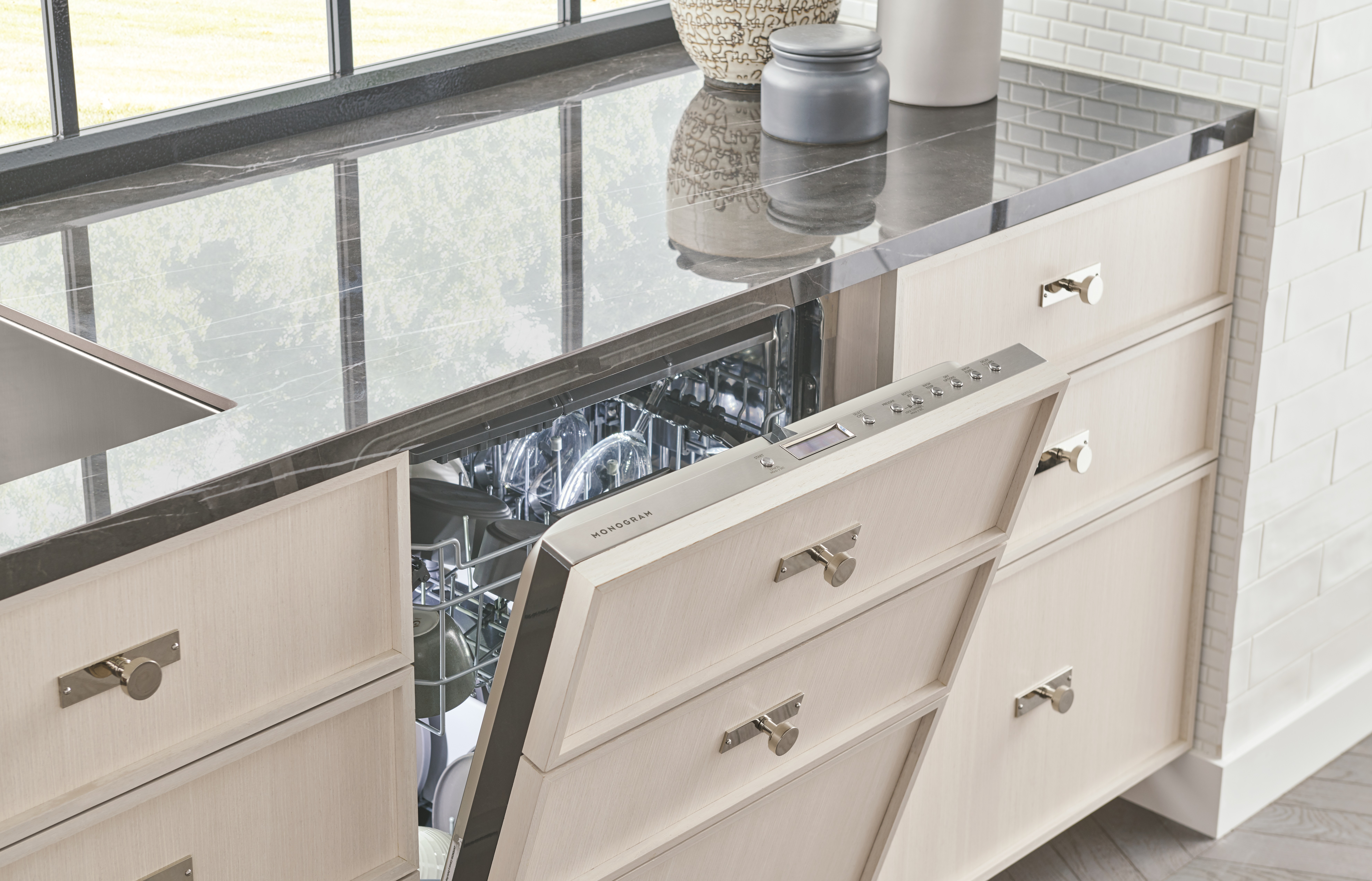 Monogram ZDT985SINII dishwasher shown slightly ajar