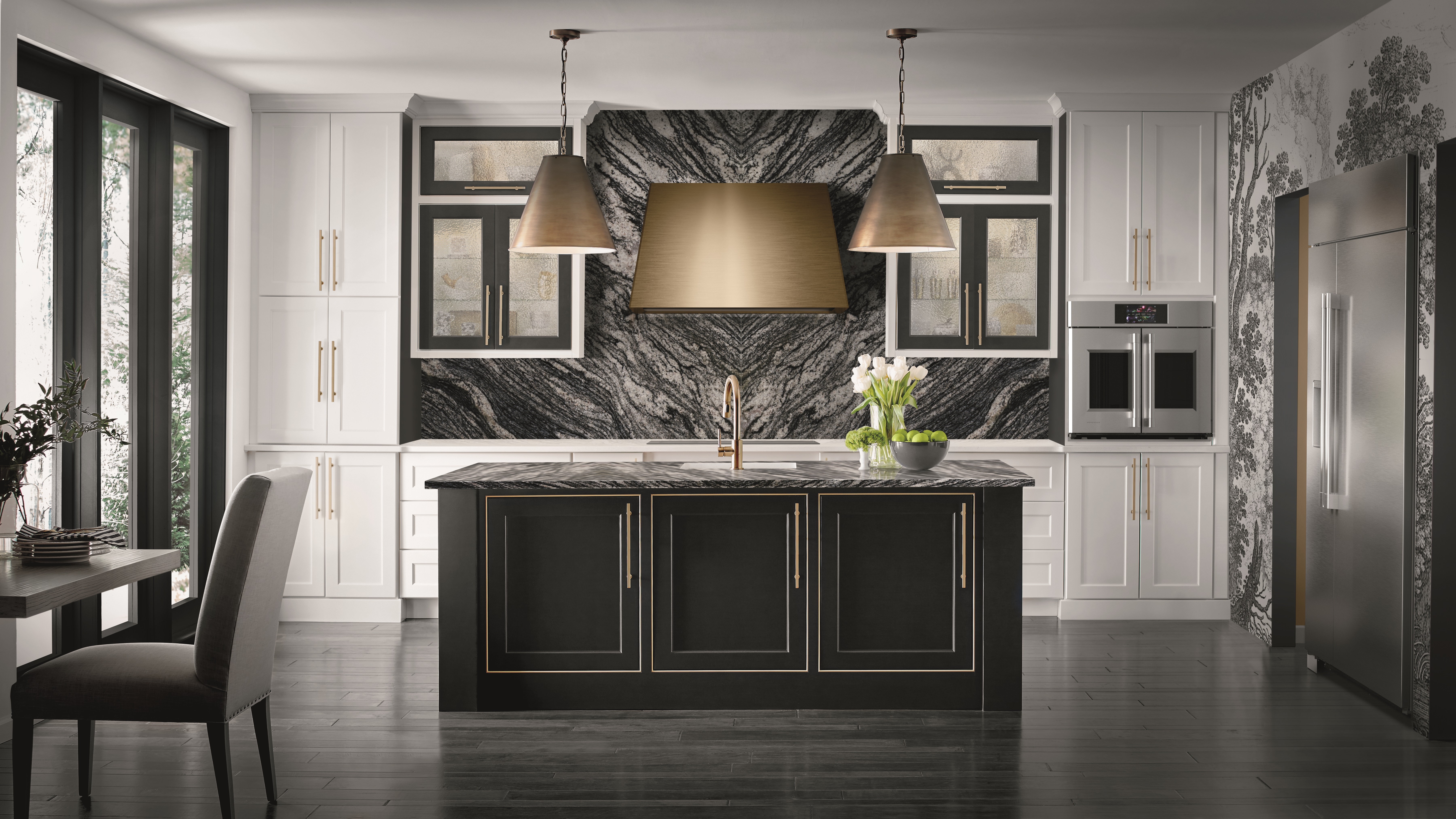 A black and white kitchen featuring several Monogram kitchen appliances 