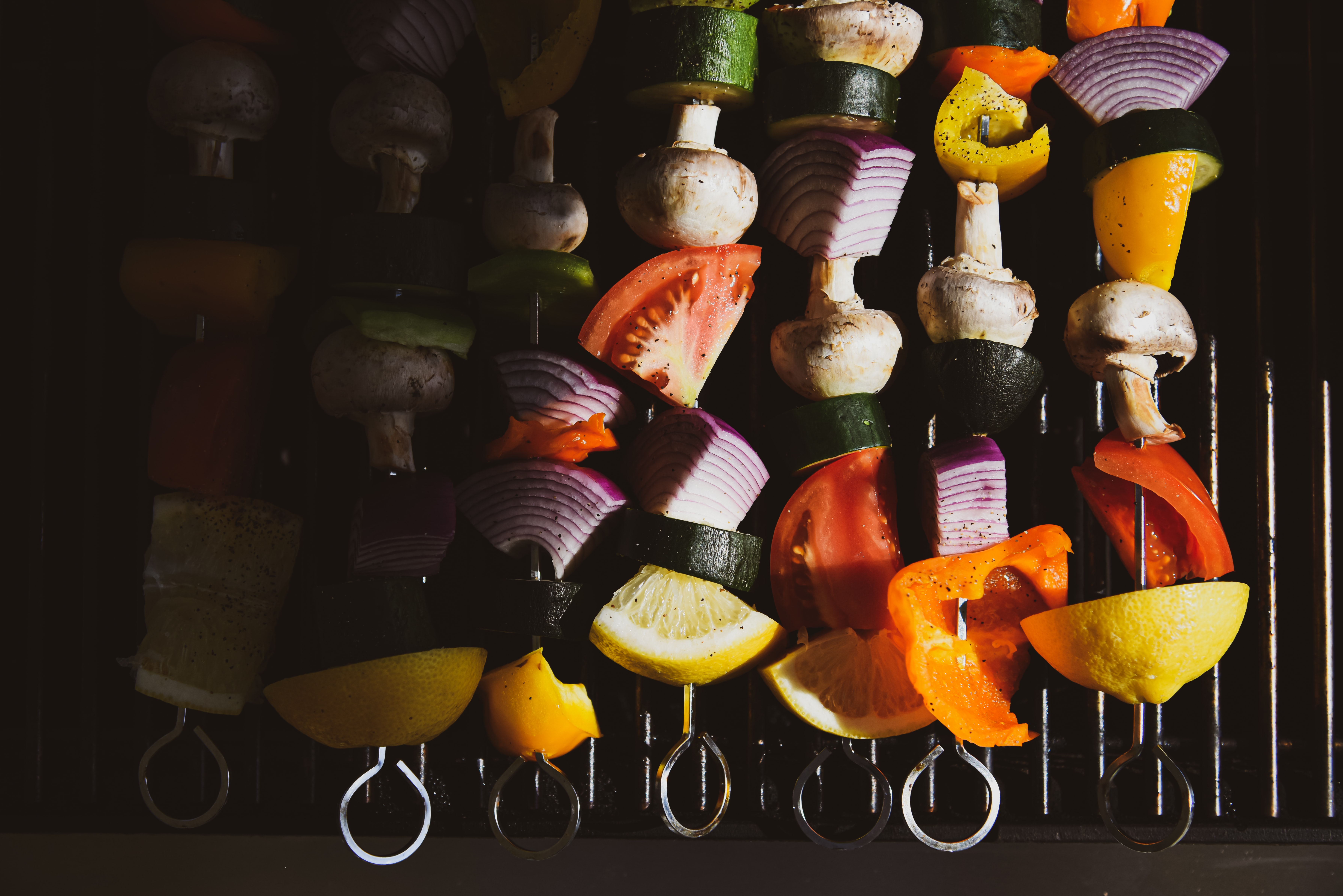 Vegetable kabobs cooking on a grill 