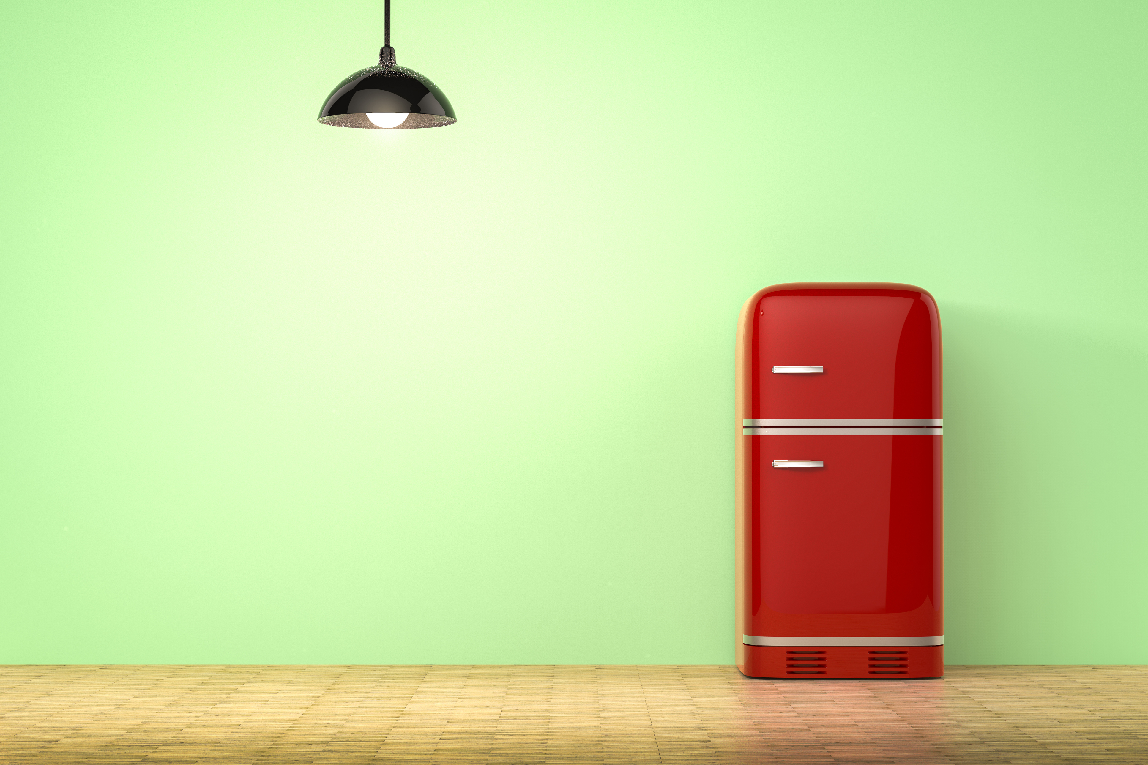 A red retro-style refrigerator against a green wall 