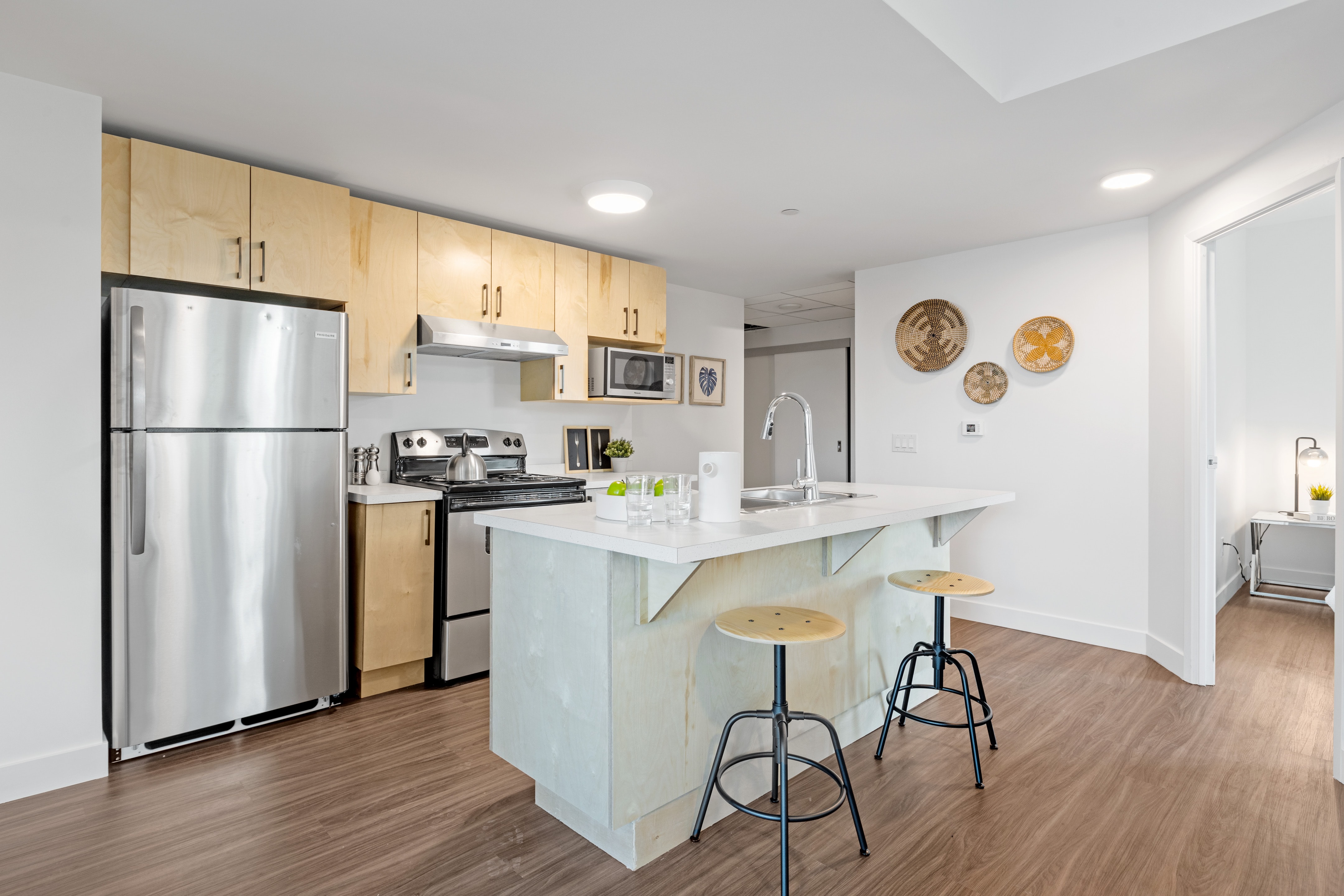 A modern kitchen featuring a stainless steel top-freezer refrigerator 