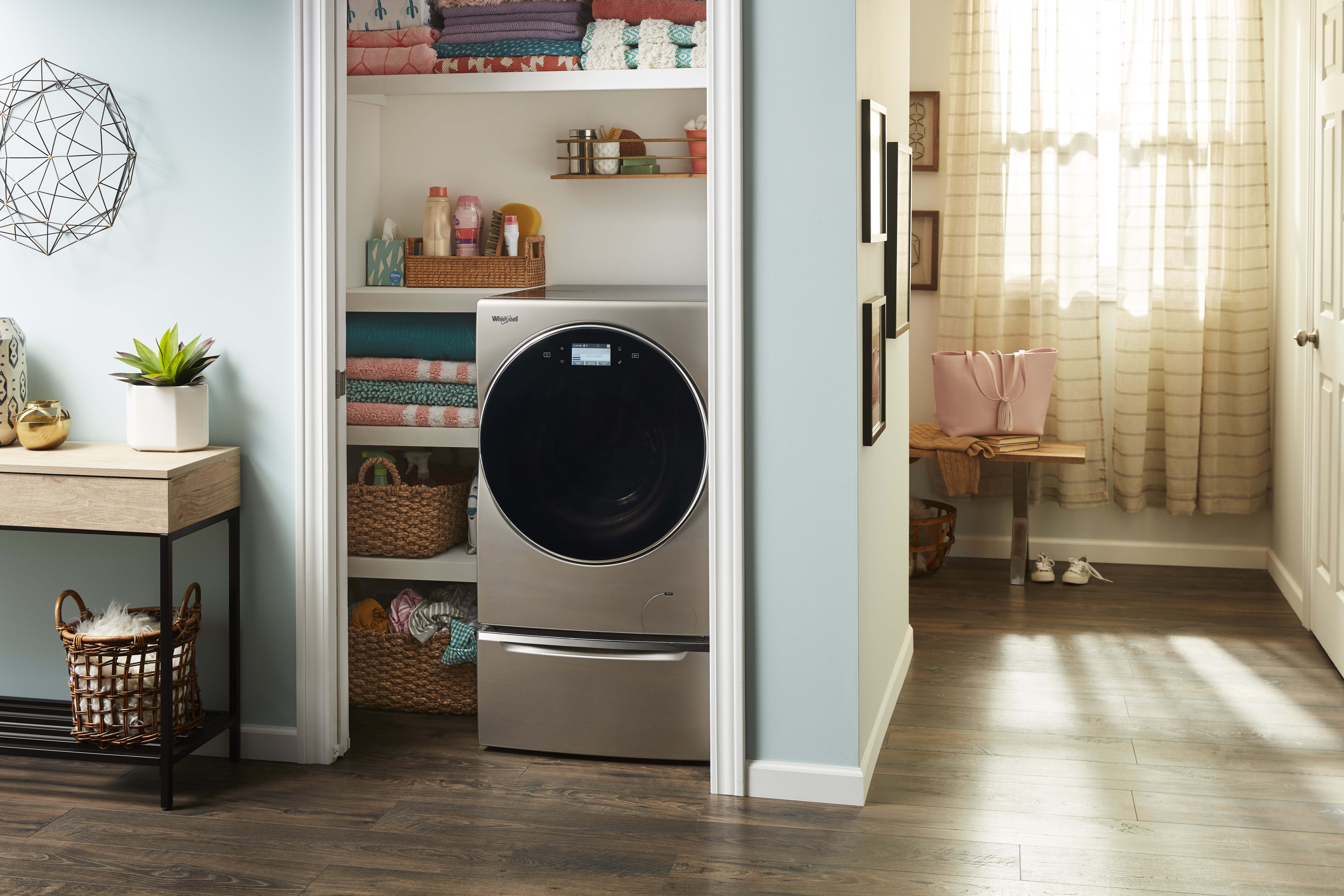 Whirlpool WFC8090GX washer dryer combo shown installed into a closet