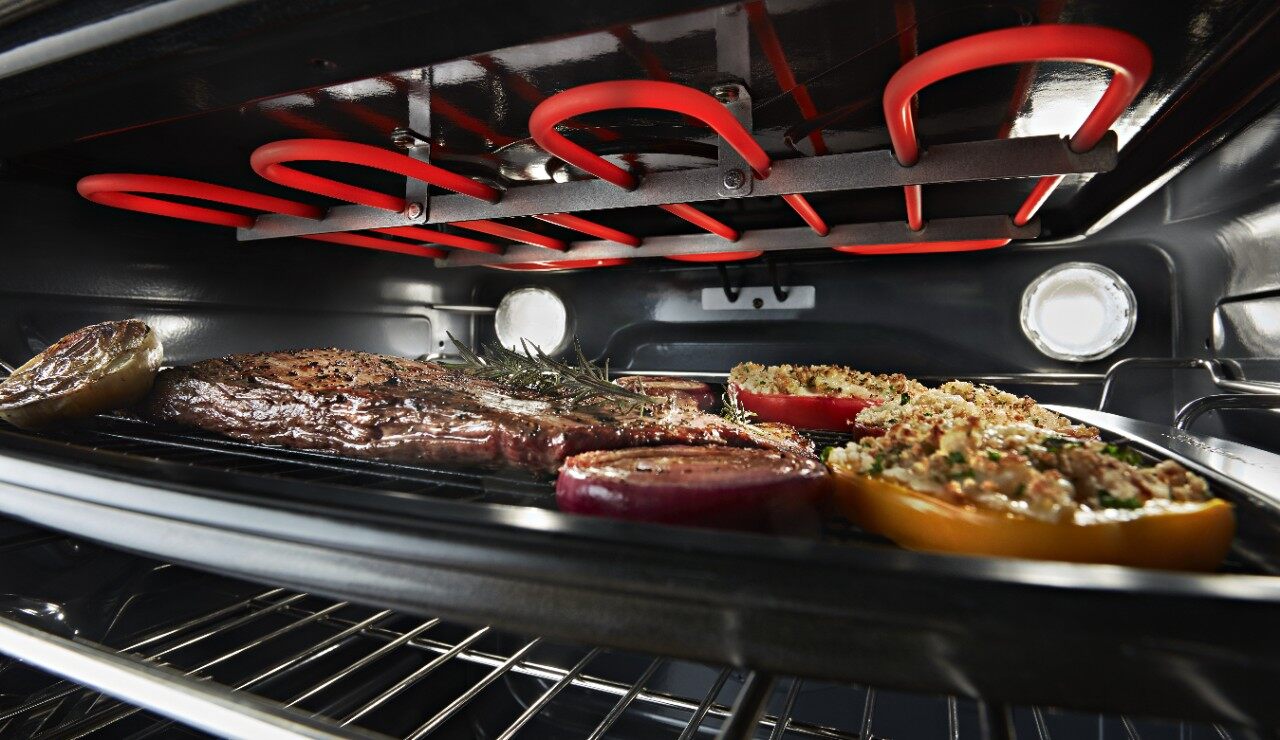 Inside of an electric range cooking dinner