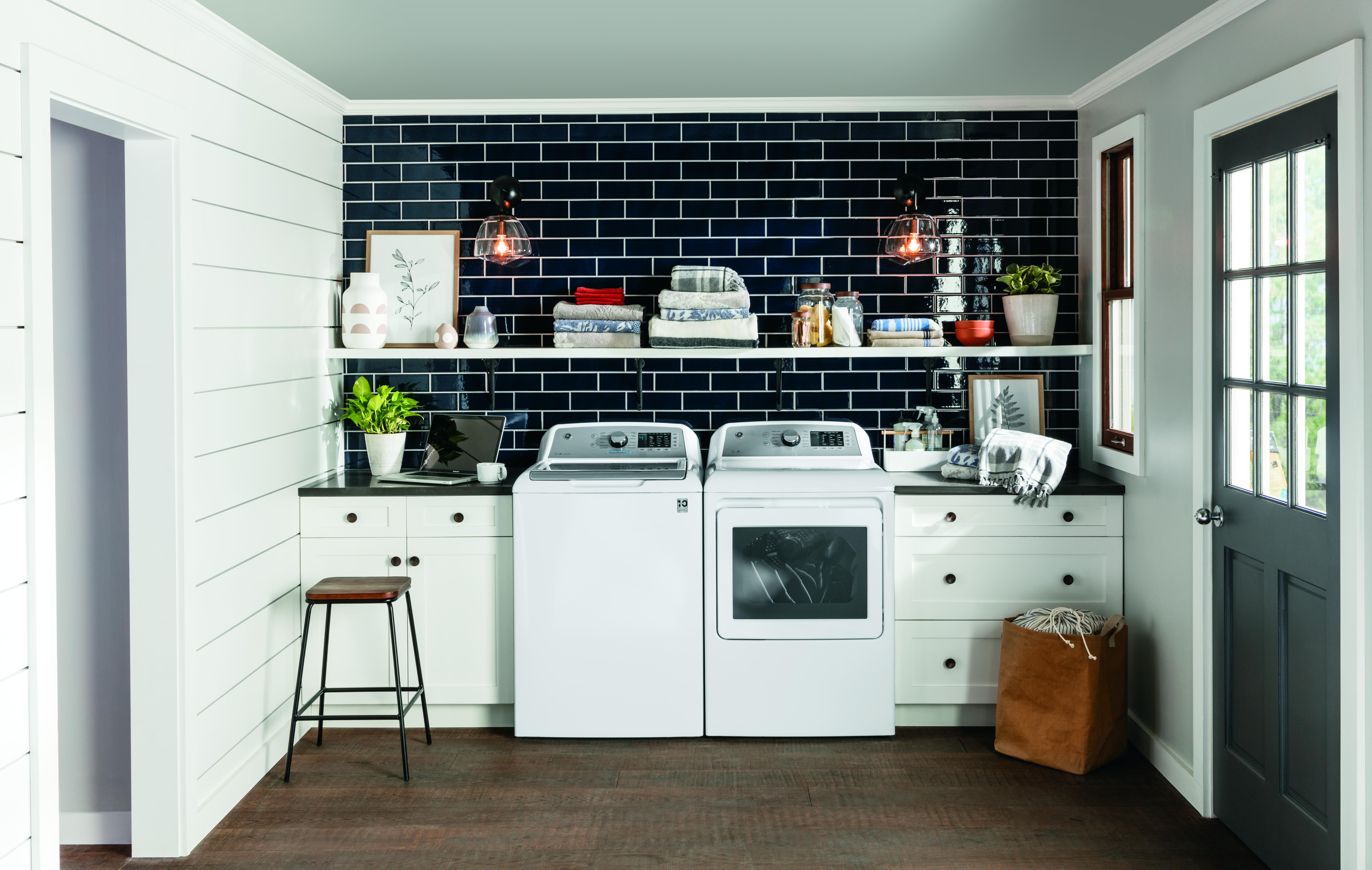 white front load GE washer and dryer set in modern laundry room 