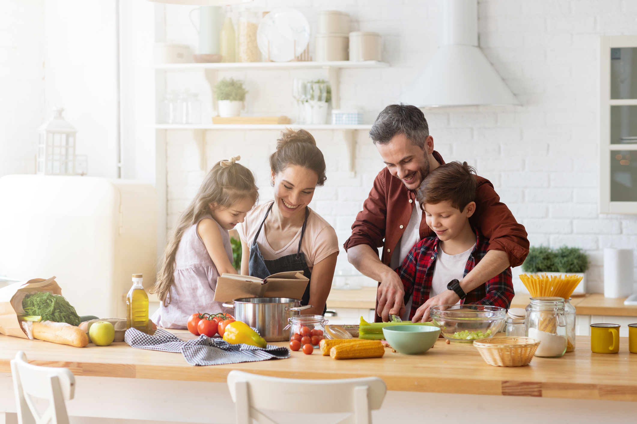 family reading recipes and chopping veggies together
