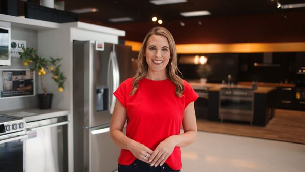IA Fred’s Appliance associate smiling against a background of appliances