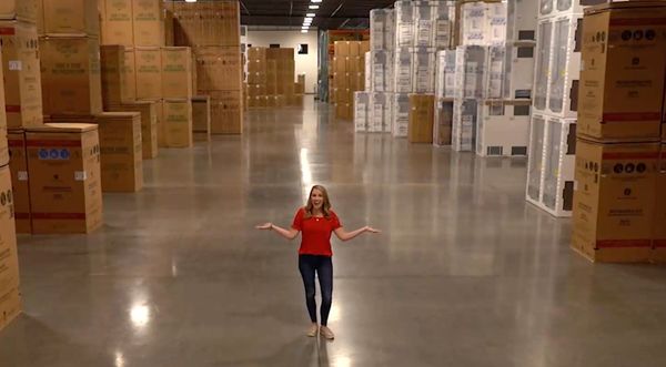 A Fred’s Appliance associate smiling against a background of appliances