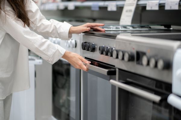 A woman shopping for electric ranges
