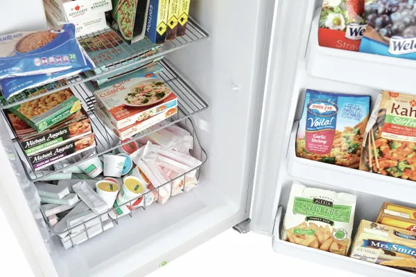 A variety of frozen food inside the Frigidaire FFFU16F2VW freezer