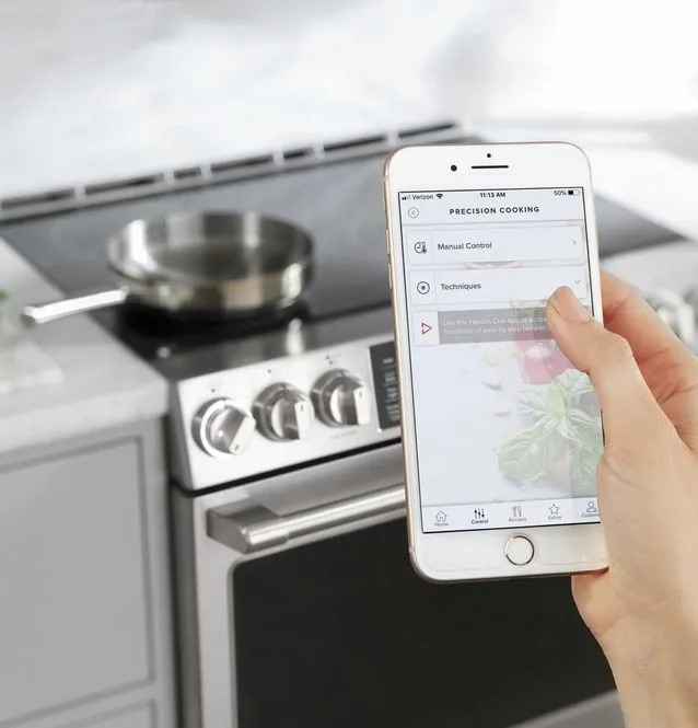 A person using the smart feature on the Café CHS90XP2MS1 induction range