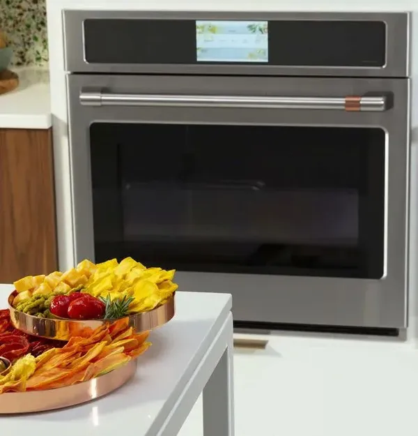 The Cafe CTS90DP2NS1 wall oven featured with a platter of appetizers 