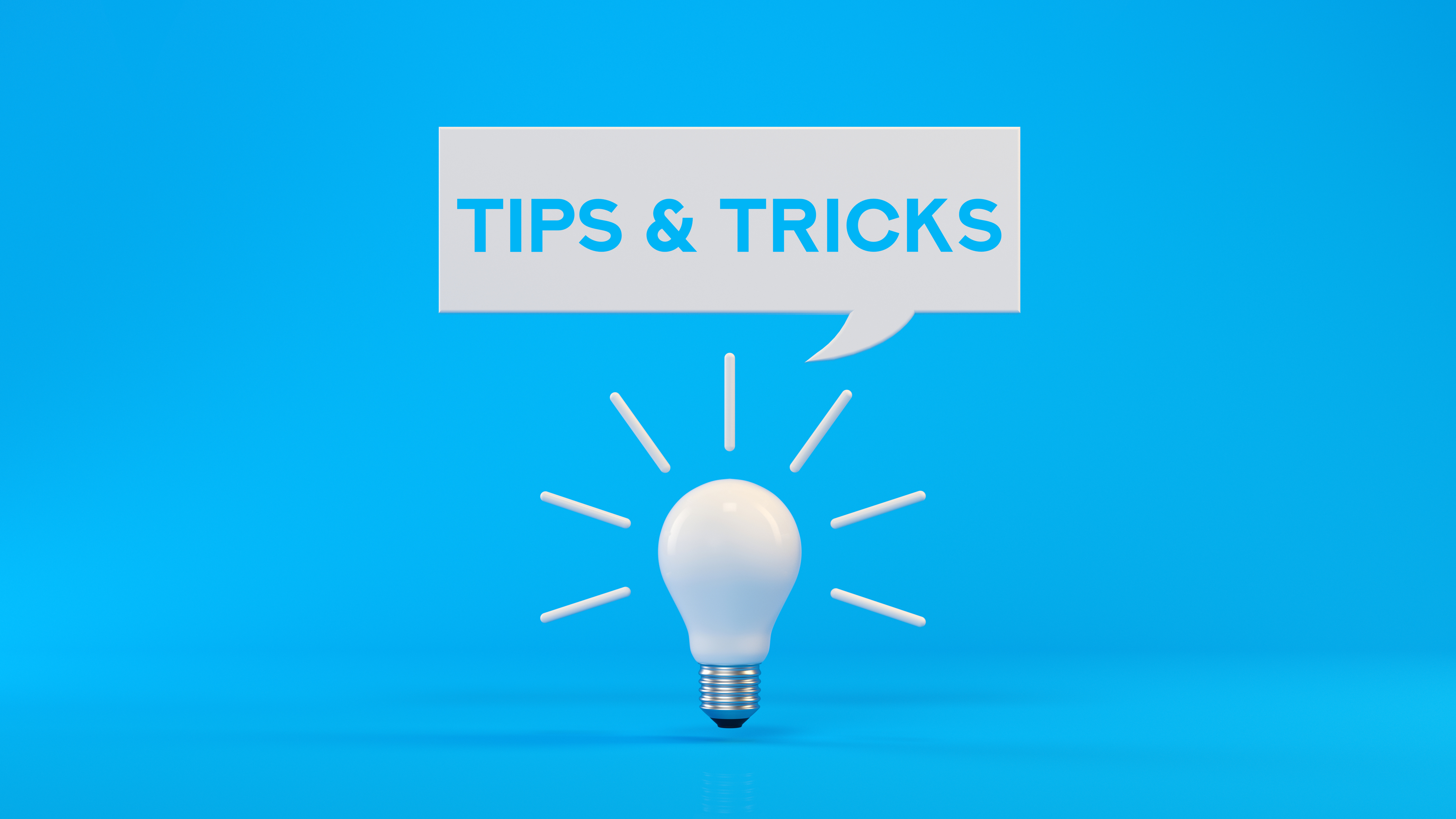 A lightbulb and graphic conversation bubble saying tips and tricks against a blue background