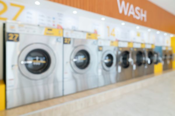 A blurred image of a wall of front load washers 