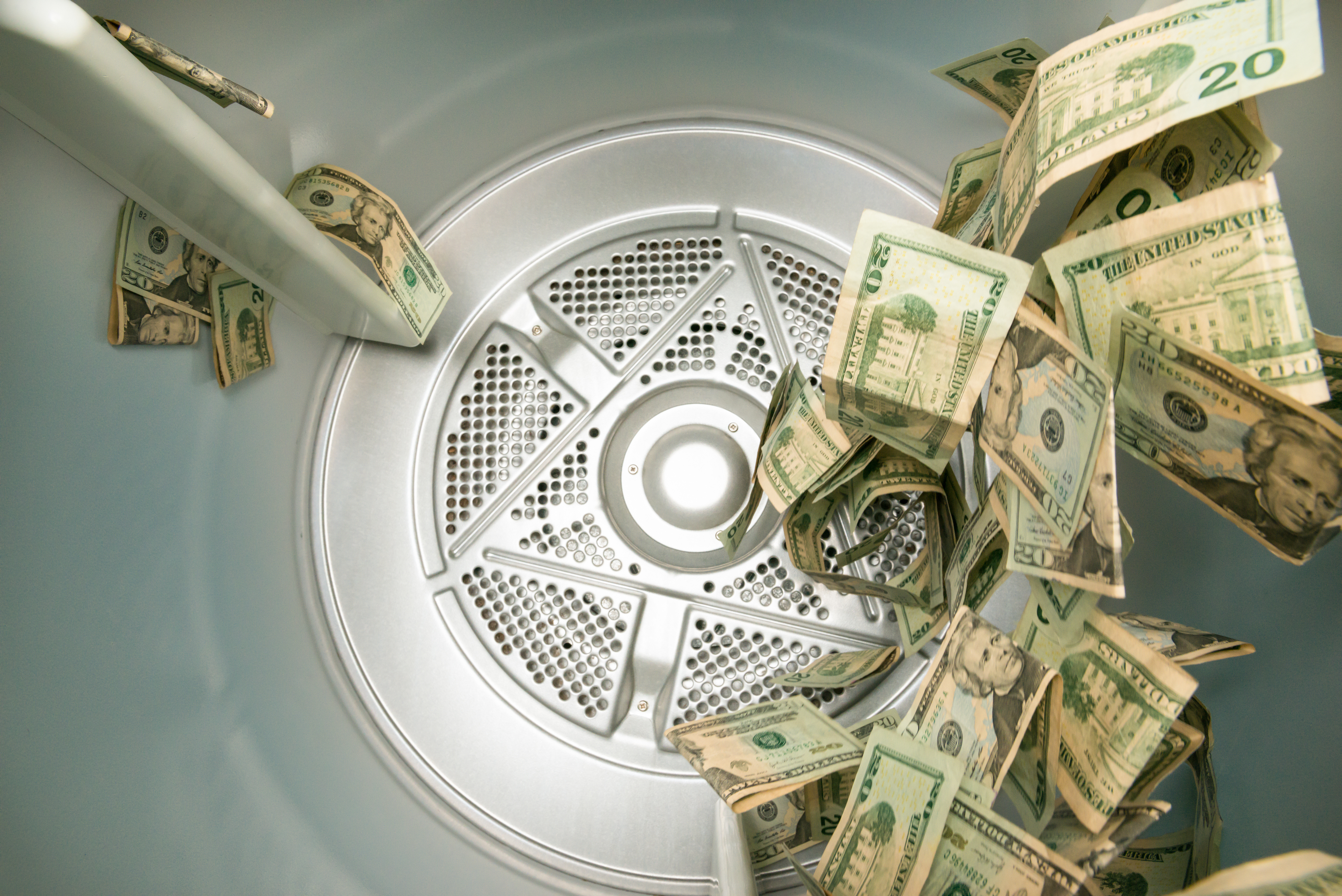 Dollar bills rolling around in a dryer 