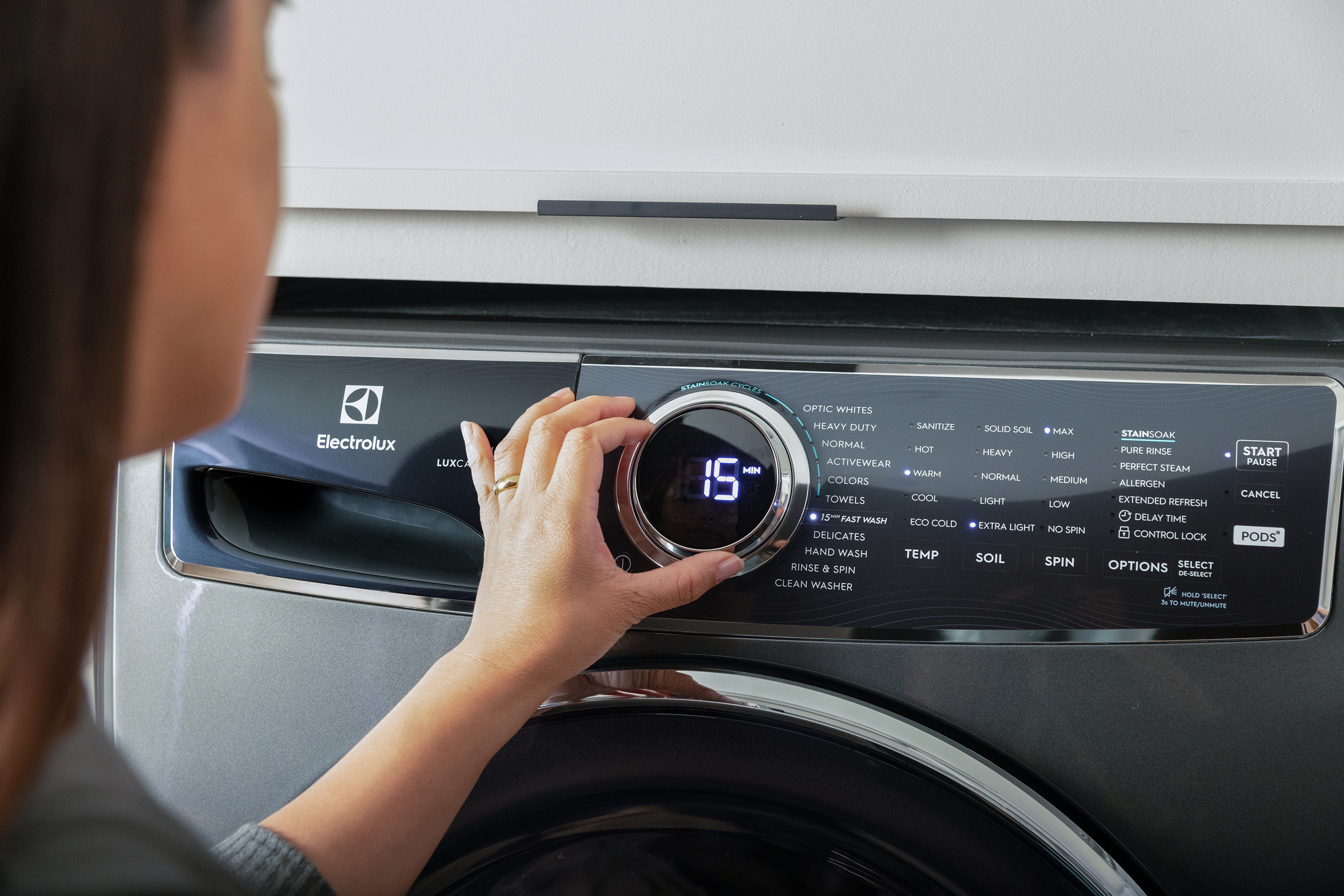 A woman using an Electrolux washer 