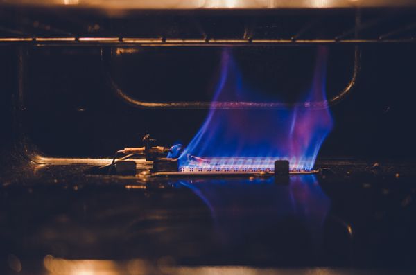 A flame within a gas oven 