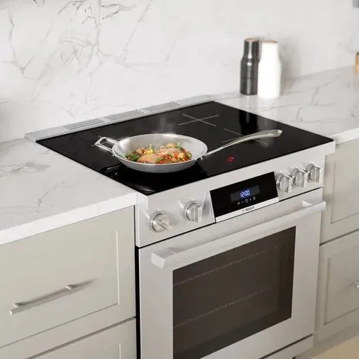 A pan cooking food on the Bosch 800 Series HIS8055U 30” induction range