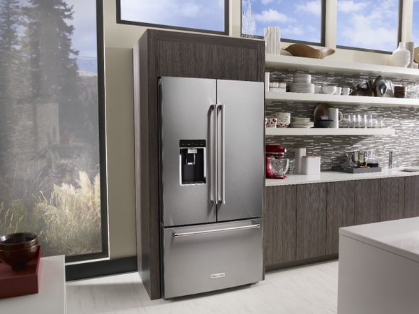 A KitchenAid counter depth refrigerator in a kitchen 
