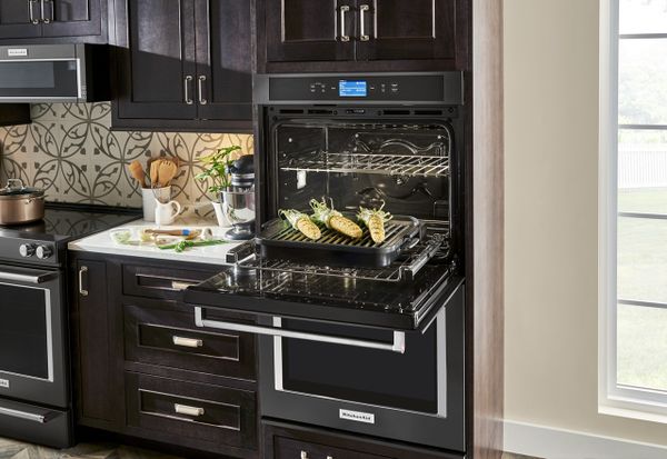A KitchenAid black double oven featuring ears of corn