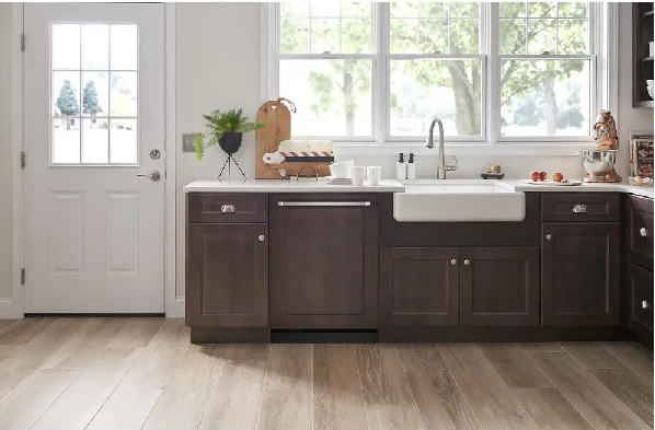 The KitchenAid KDTE304LPA  panel ready dishwasher shown in a custom brown wood finish