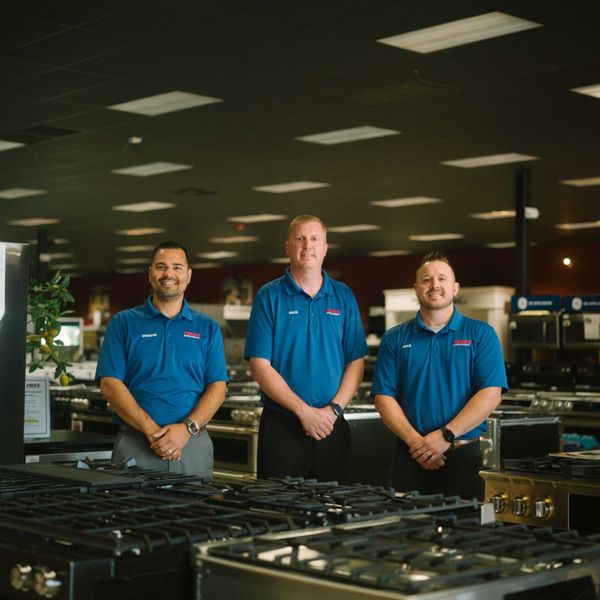 Three sales Fred’s Appliance sales associates featured in a store