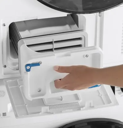 A person removing a condenser from a GE ventless dryer