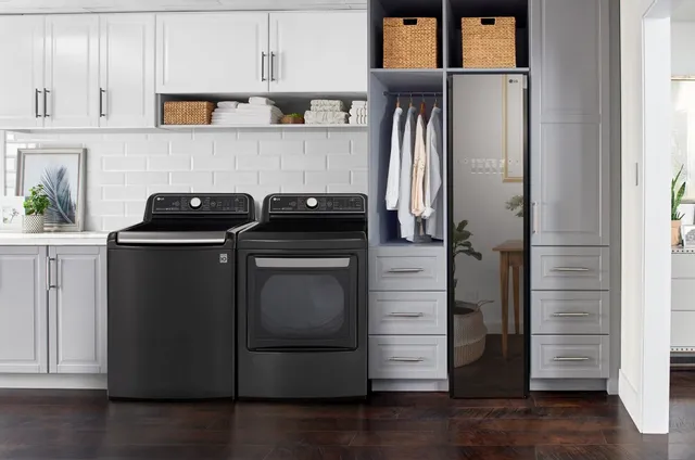 A laundry room featuring the LG WT7900HBA black top load washer and matching dryer 