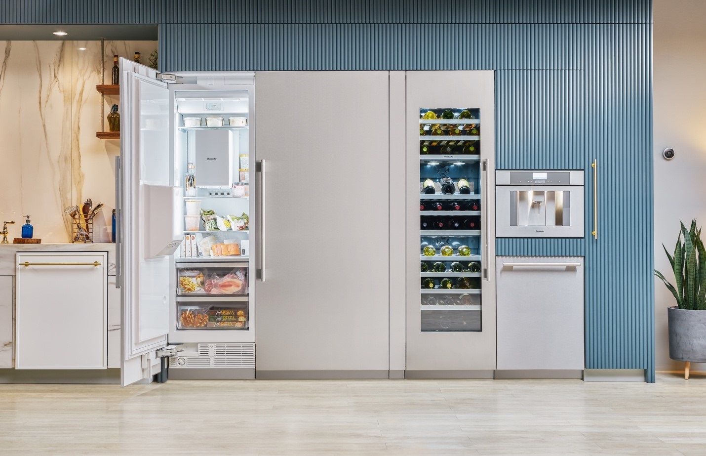 Thermador column refrigerator and freezer and a luxury kitchen with a marble backsplash