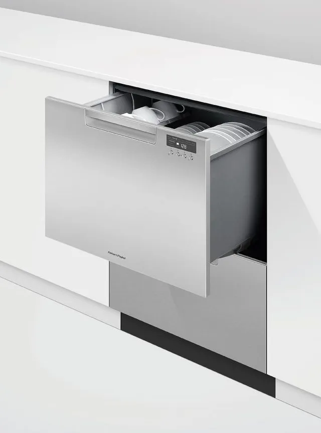 The Fisher & Paykel DD24DCTX9 N 7 Series double dishwasher drawer installed in a wall 