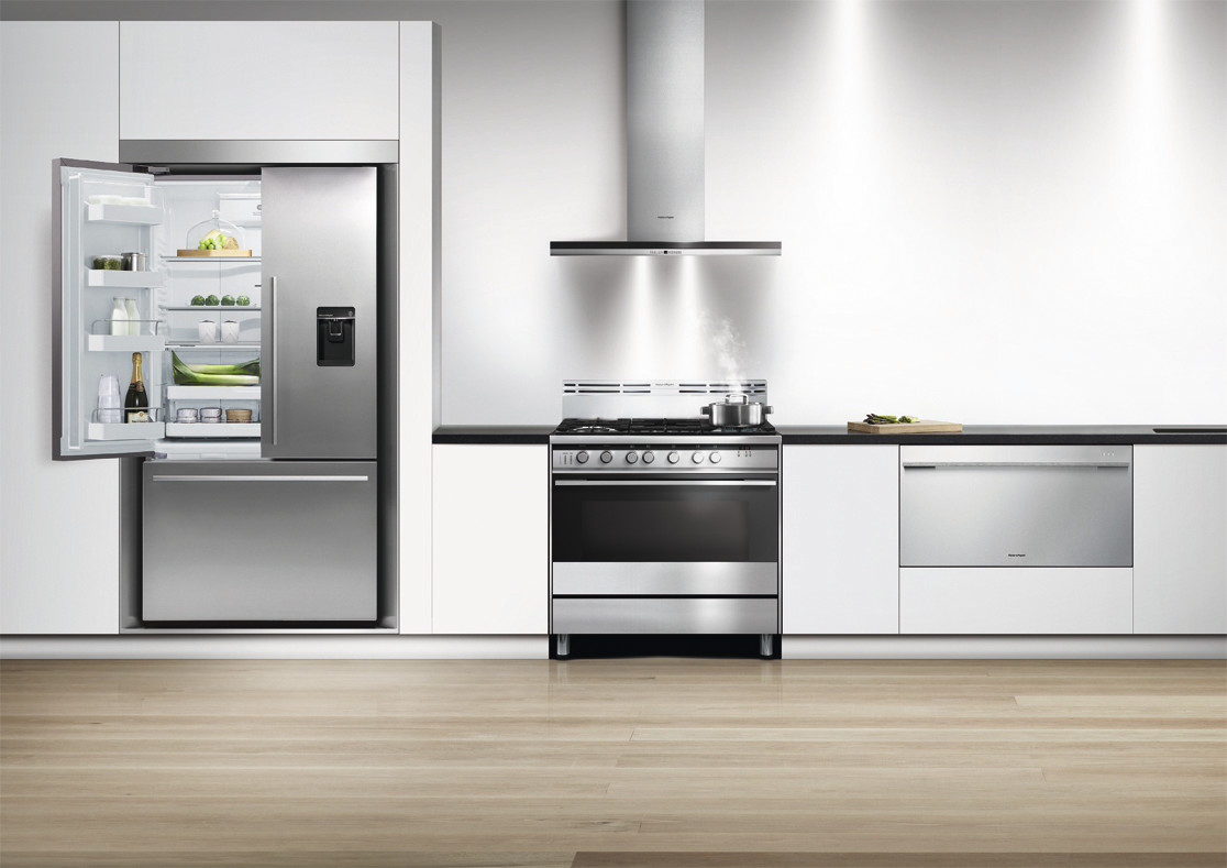 A kitchen featuring a Fisher & Paykel refrigerator, range, range hood, and drawer dishwasher 