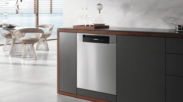 Side view of Miele fully integrated Miele dishwasher installed under a countertop 