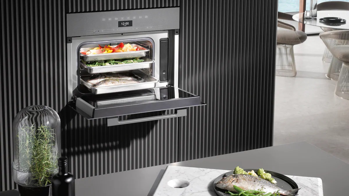 An open steam oven reveals freshly steamed food