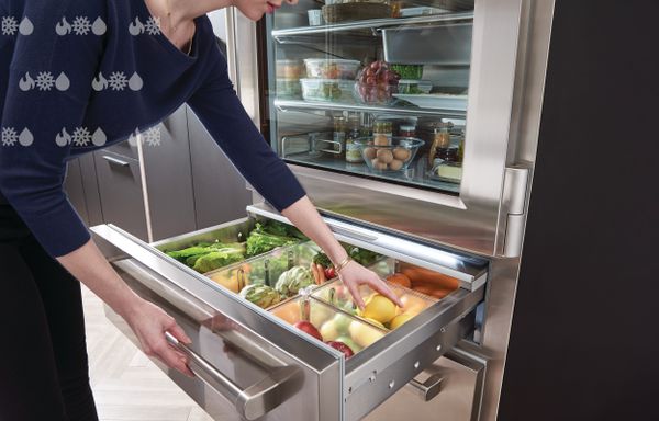 Woman Reaching into SubZero Refrigerator