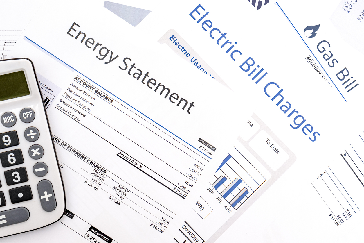 overhead of calculator and several utility bill statements