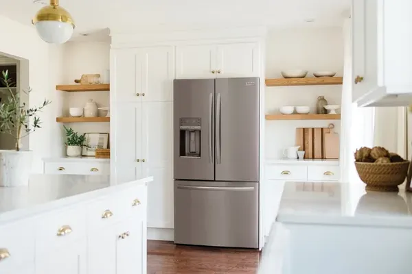 Front view of a modern kitchen with a stainless steel Frigidaire Gallery French Door Refrigerator