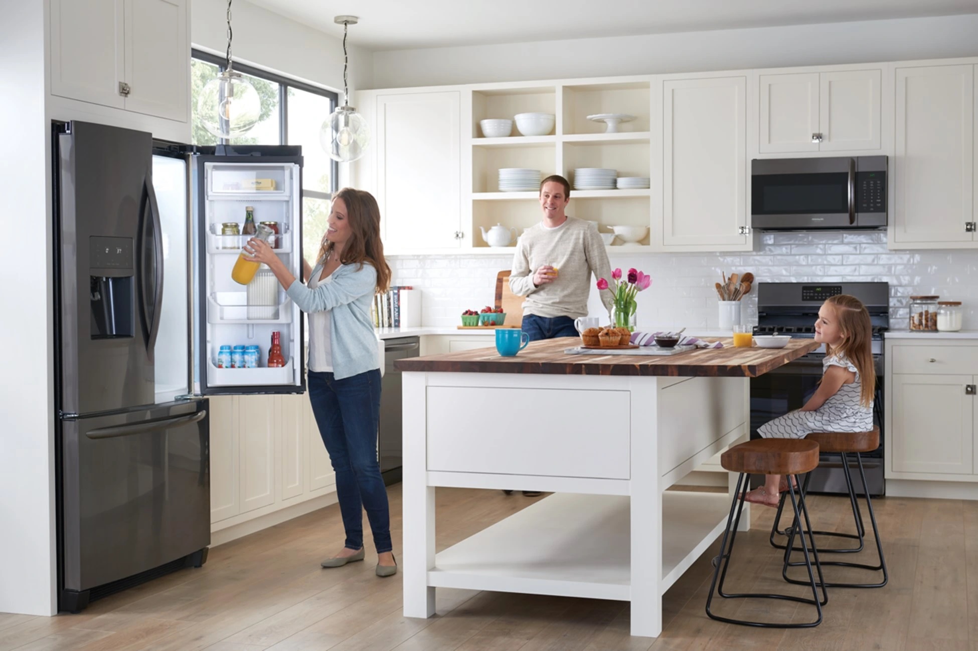 mother returns orange juice to Frigidaire French door refrigerator