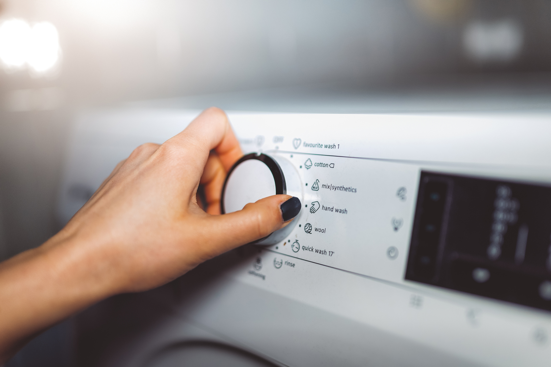 turning the dial on the washing machine