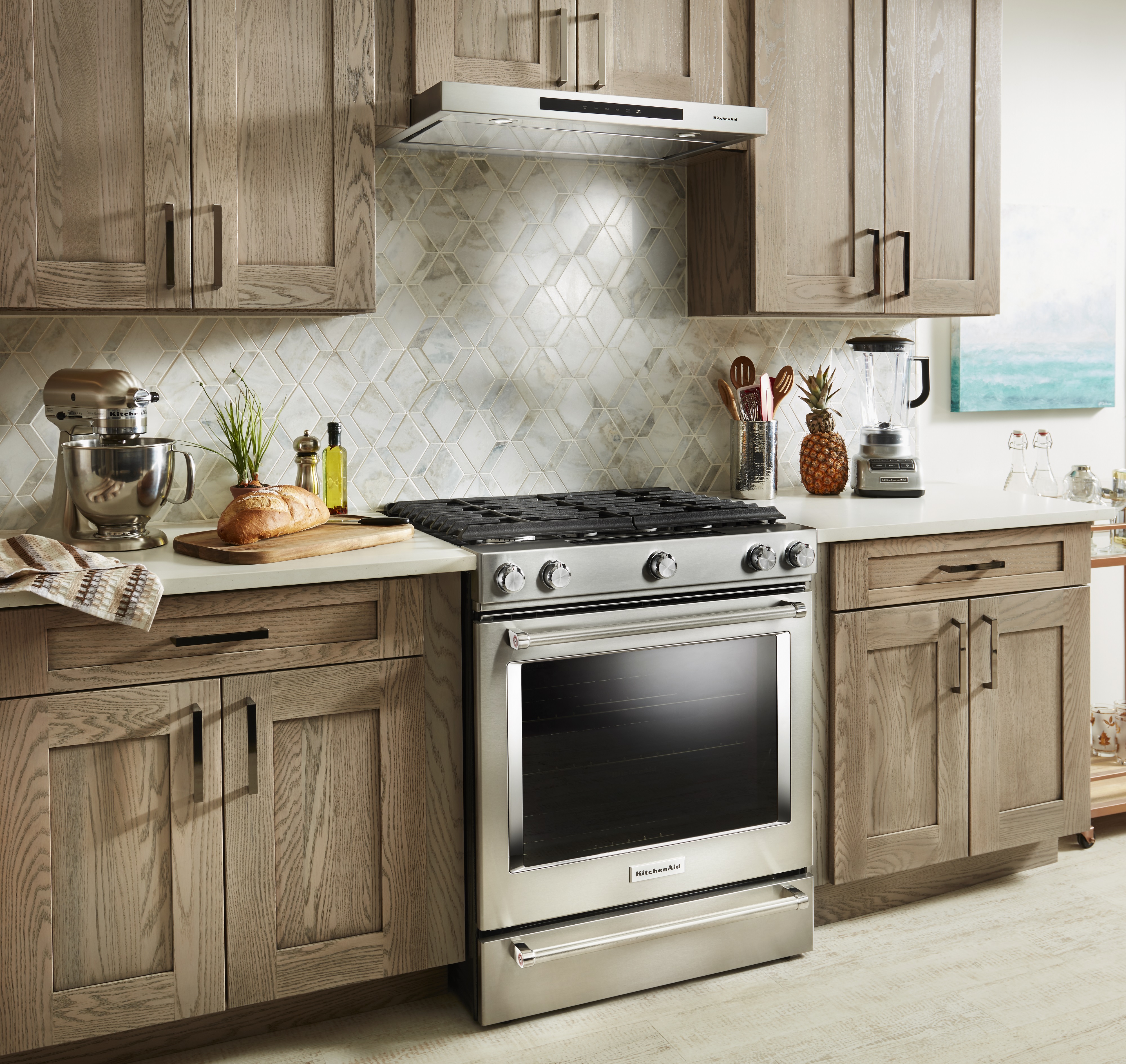 KitchenAid slide-in stainless steel gas range in modern kitchen 