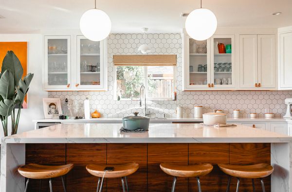 Kitchen Featuring Glass Cabinet Doors “Credit: roamincolor”
