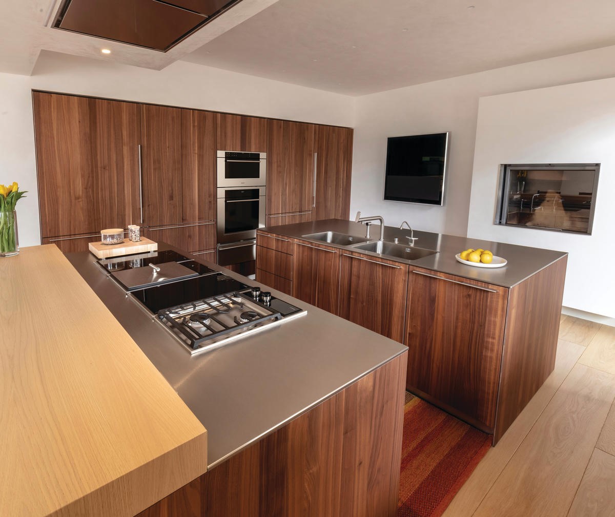 A kitchen island with module cooktops and a kitchen island with an integrated stainless-steel sink