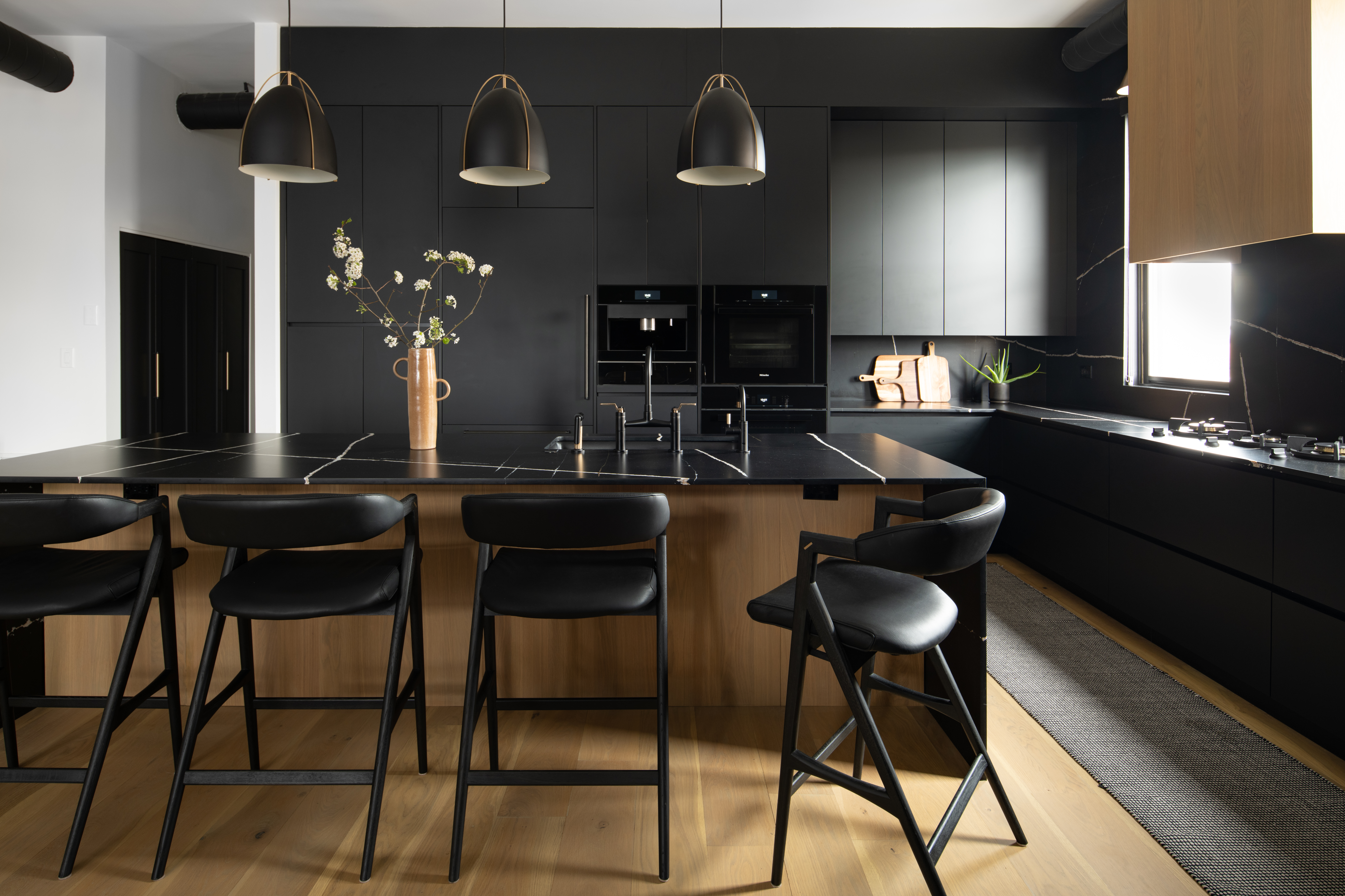 View of Metro Design Build kitchen with Miele appliances and a custom seating area