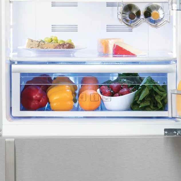 bell peppers, oranges, strawberries, and lettuce in a refrigerator drawer