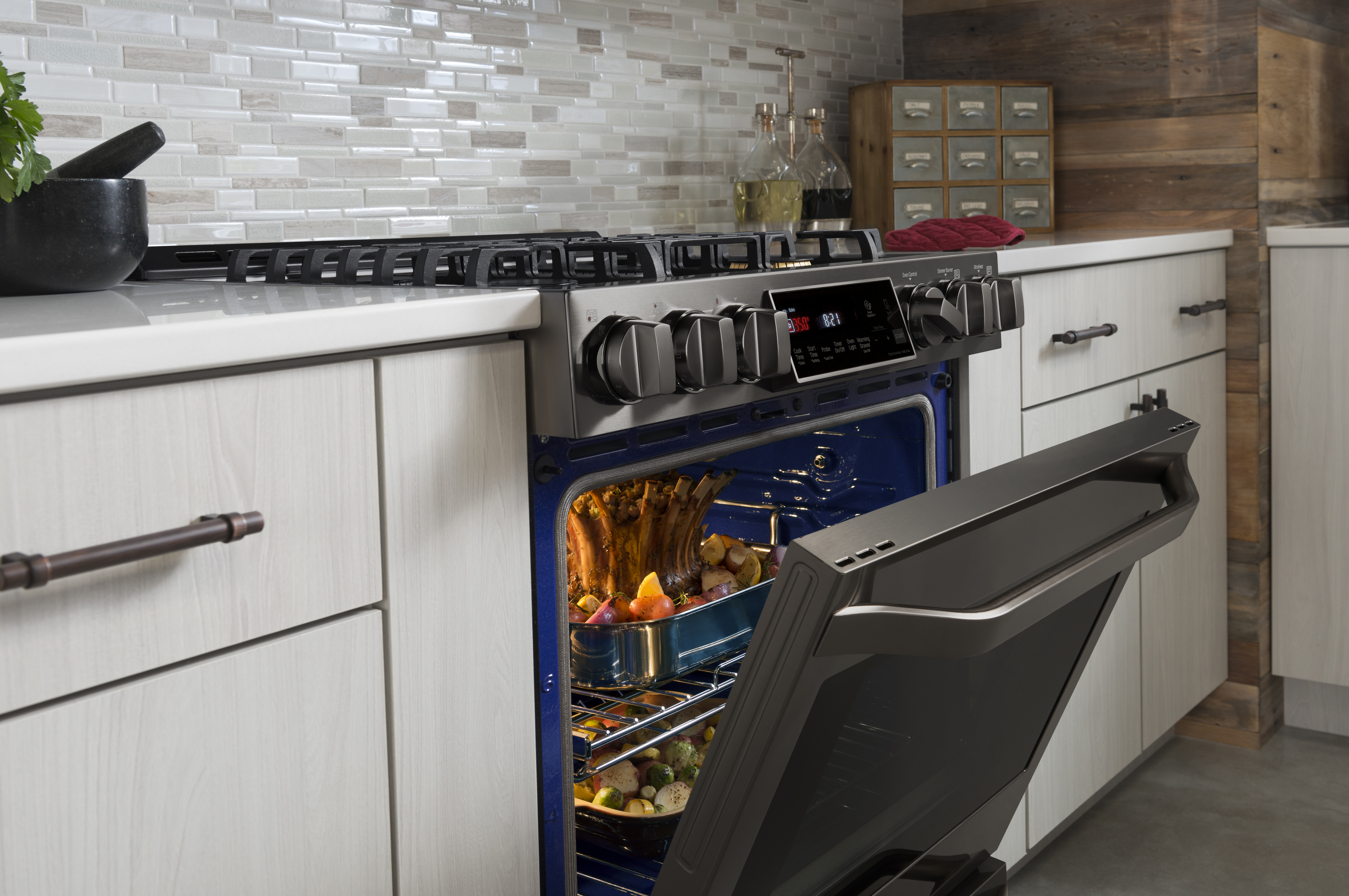 Blue EasyClean oven interior on an LG front-control gas range cooking a meal