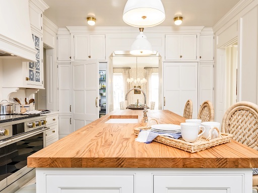 Straight-on view of Artisan Signature Homes Monogram Southern kitchen’s butcher block island and built-in refrigerators 