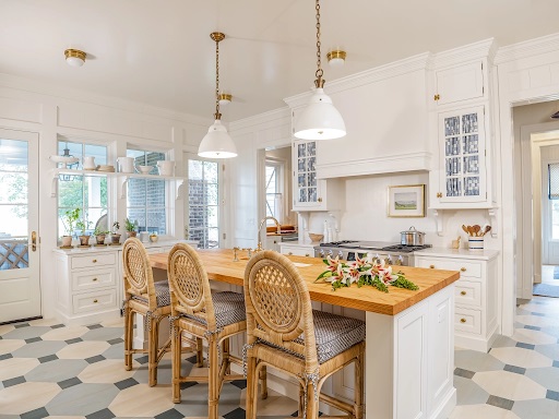 View of Artisan Signature Homes Monogram Southern kitchen with wicker seating and a butcher block island