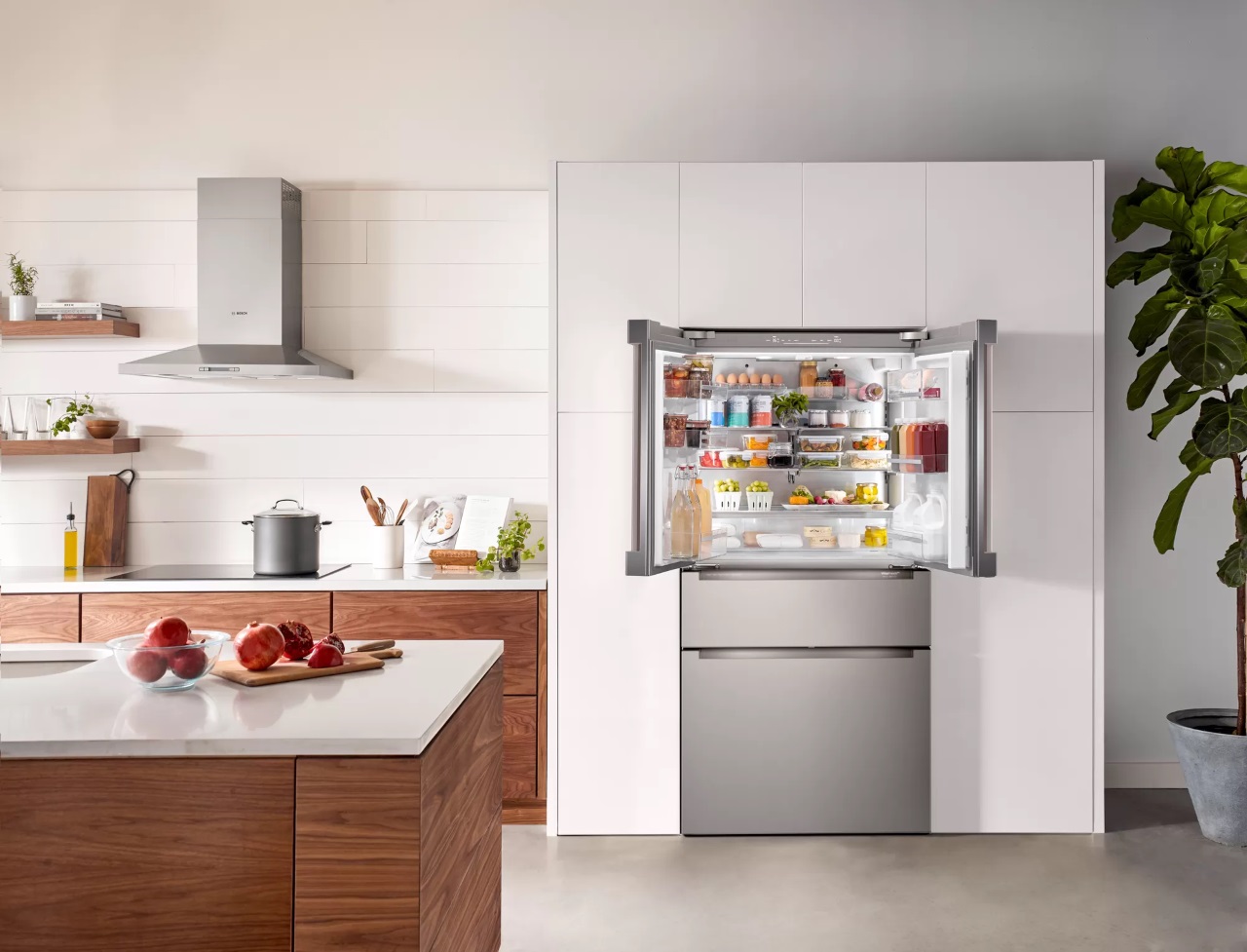 French doors open on the Bosch B36CL80ENS refrigerator installed in a bright kitchen