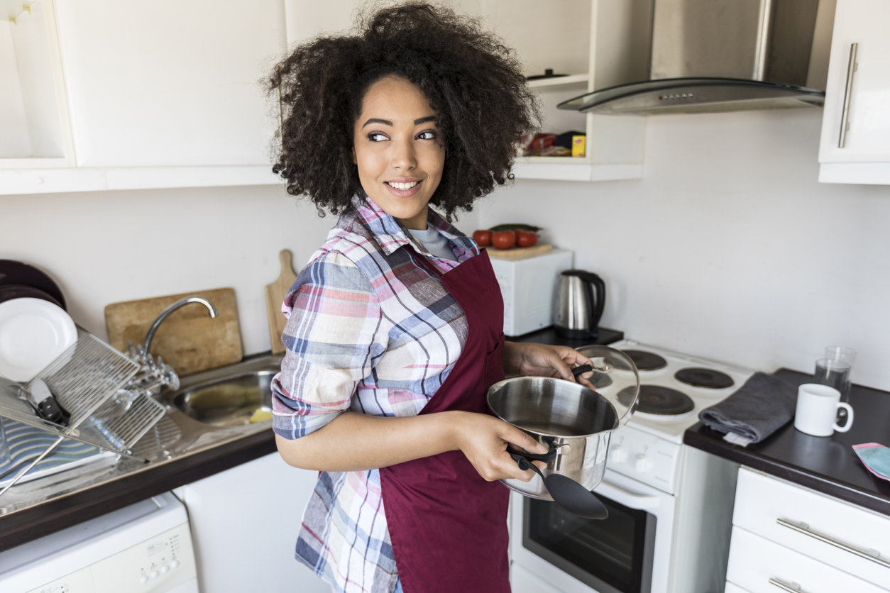 woman cooking in the kitchen with electric range