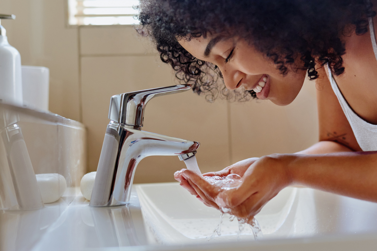young woman washing her face in the bathroom